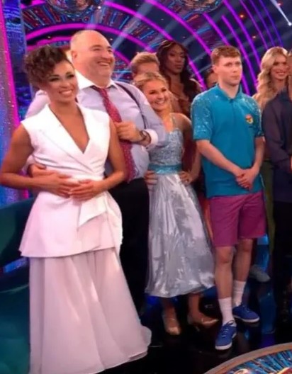 a group of people standing next to each other on a stage .