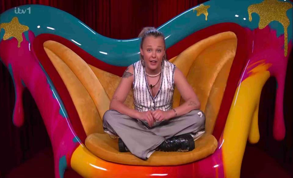 JoJo Siwa sitting in a colorful chair.