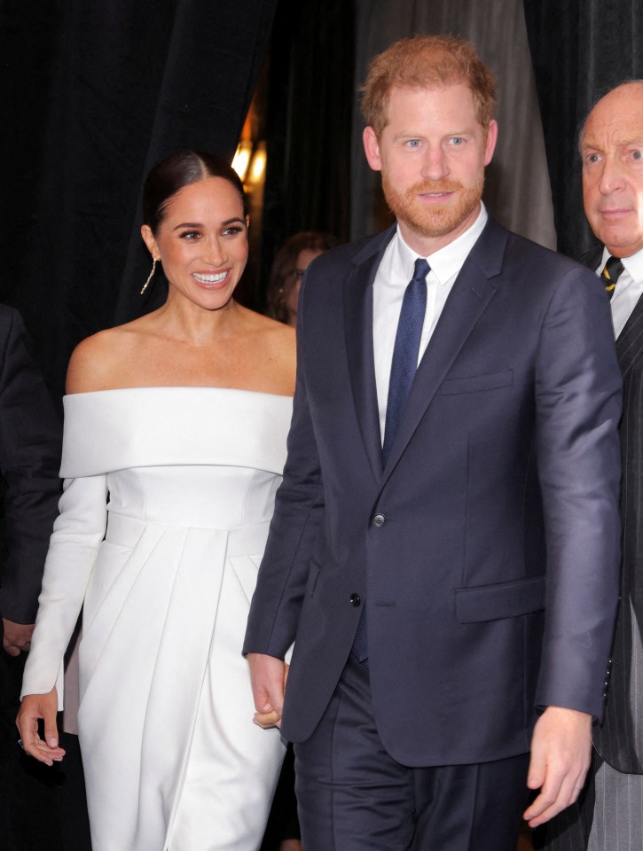 Prince Harry and Meghan Markle holding hands.