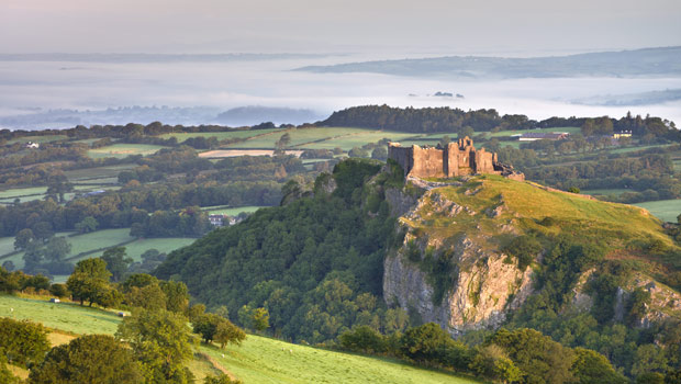 Carreg Cennen Castle at dawn on a misty summer morning, Brecon Beacons National Park, Carmarthenshire,