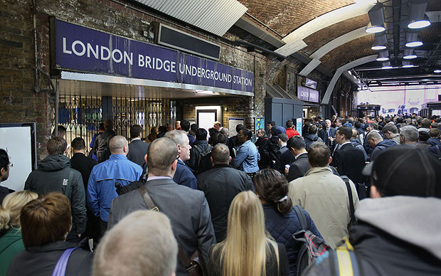 Passengers wait outside London Bridge underground station in central London, on the first day of a 48 hour strike by tube workers on the London Underground over ticket office closures.