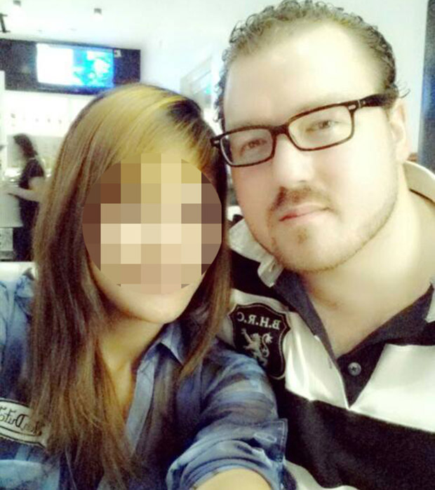 Rurik Jutting, black and white shirt.- with girlfriend, name unknown.