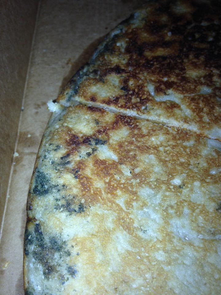 The pizza appeared to have black mould on its base