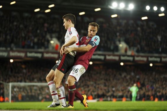 Noble cause ... West Ham star Mark takes Man Utd matters into his own hands