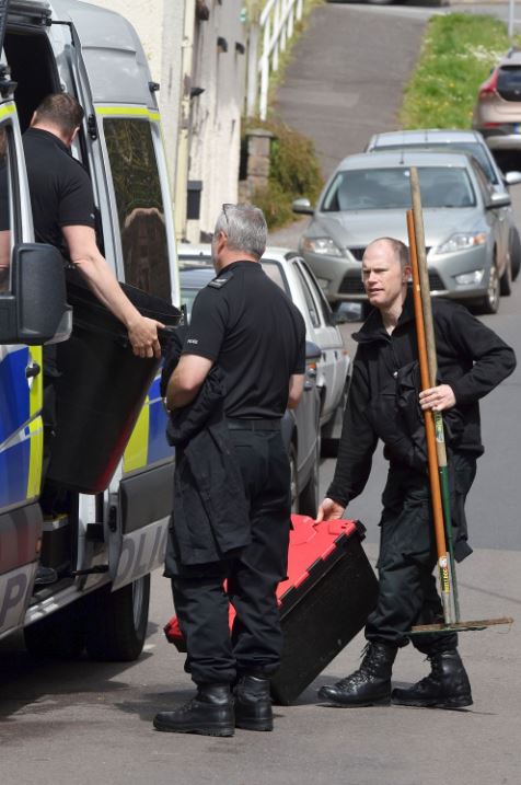 Search ... forensics officers carrying shovels and pickaxes were hunting for clues