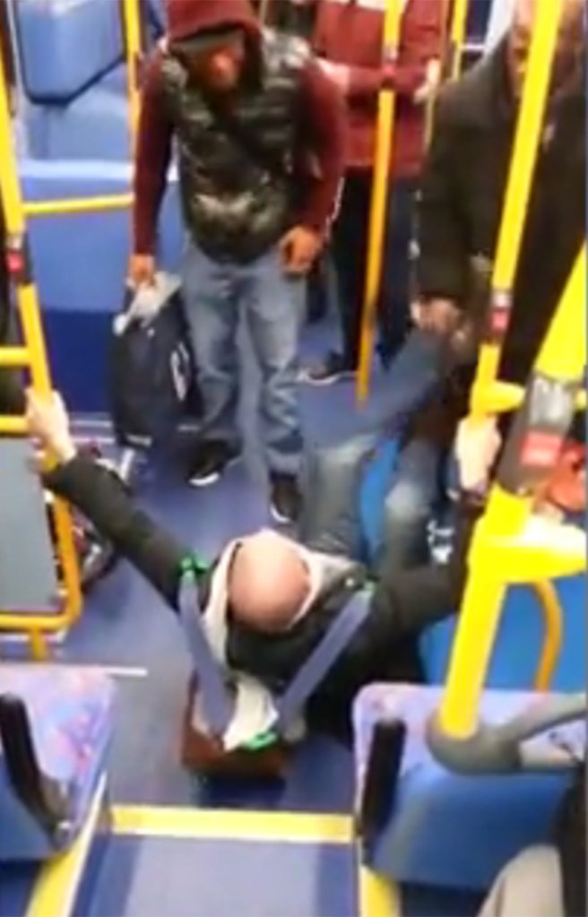 The video begins with the white passenger sprawled on the floor, as the two hurl insults at each other