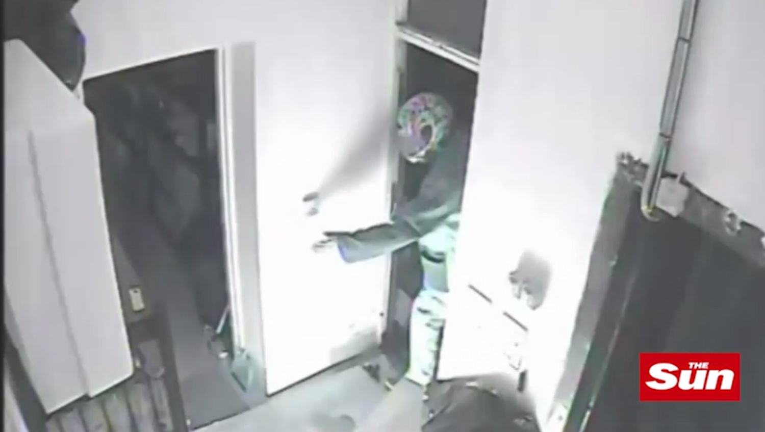 The attacker lights a fire before ducking out of a side door
