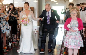 Paralysed dad fulfils dream of walking his daughter down the aisle — with the help of a BIONIC SUIT