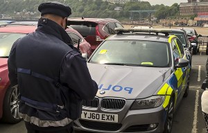 Moment crowds cheer as traffic warden gives a ticket to a police car after it overstayed in car park
