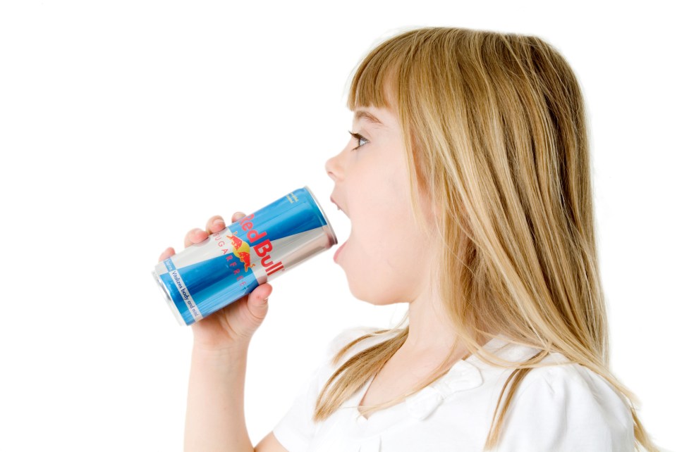 girl child kid drinking red bull energy drink high caffeine taurine slim can young