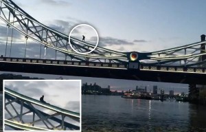 Man dices with death by climbing onto the suspension supports of Tower Bridge and smoking cigarettes