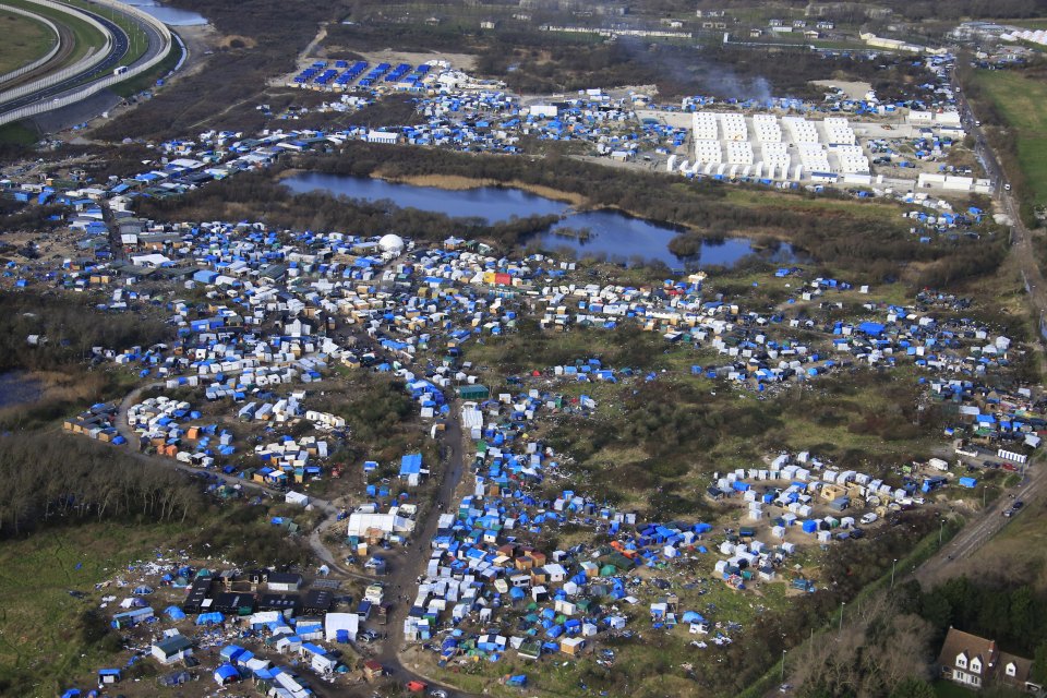 Aerial view of a makeshift camp as containers are put into place to house several hundred migrants living in what is known as the "Jungle", a squalid sprawling camp in Calais, northern France