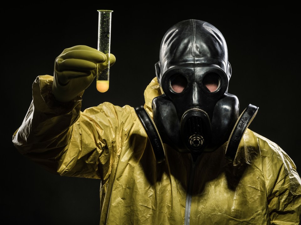Man with gas mask and hazmat suit