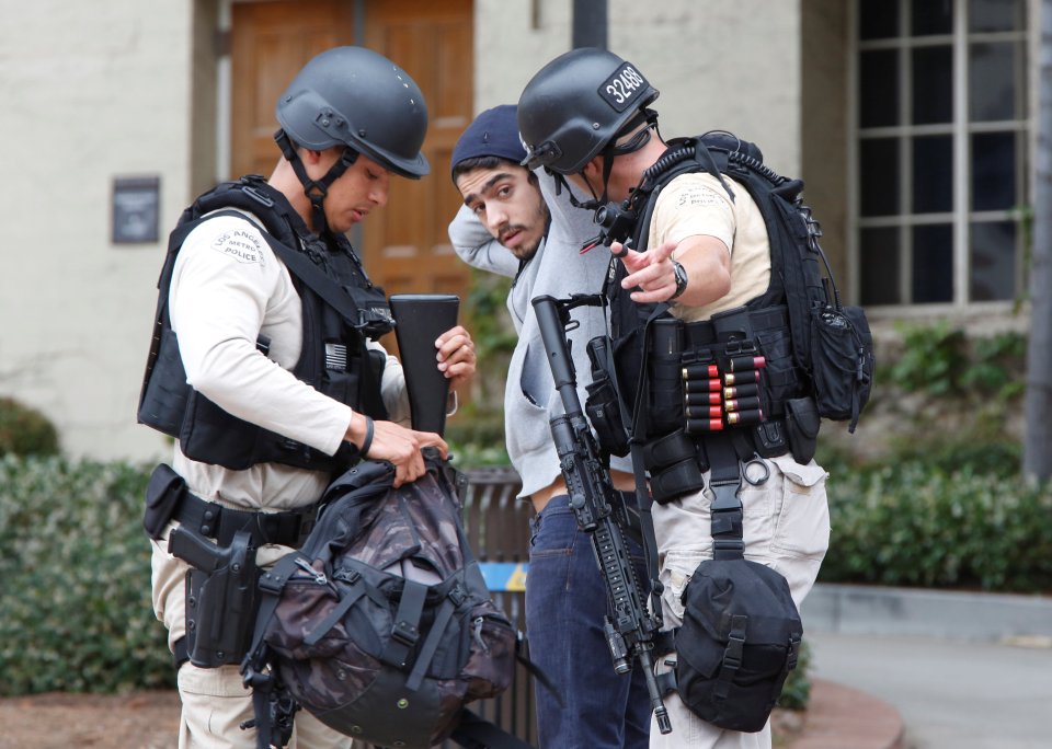 Heavily armed officers search an anxious student following the lockdown alert