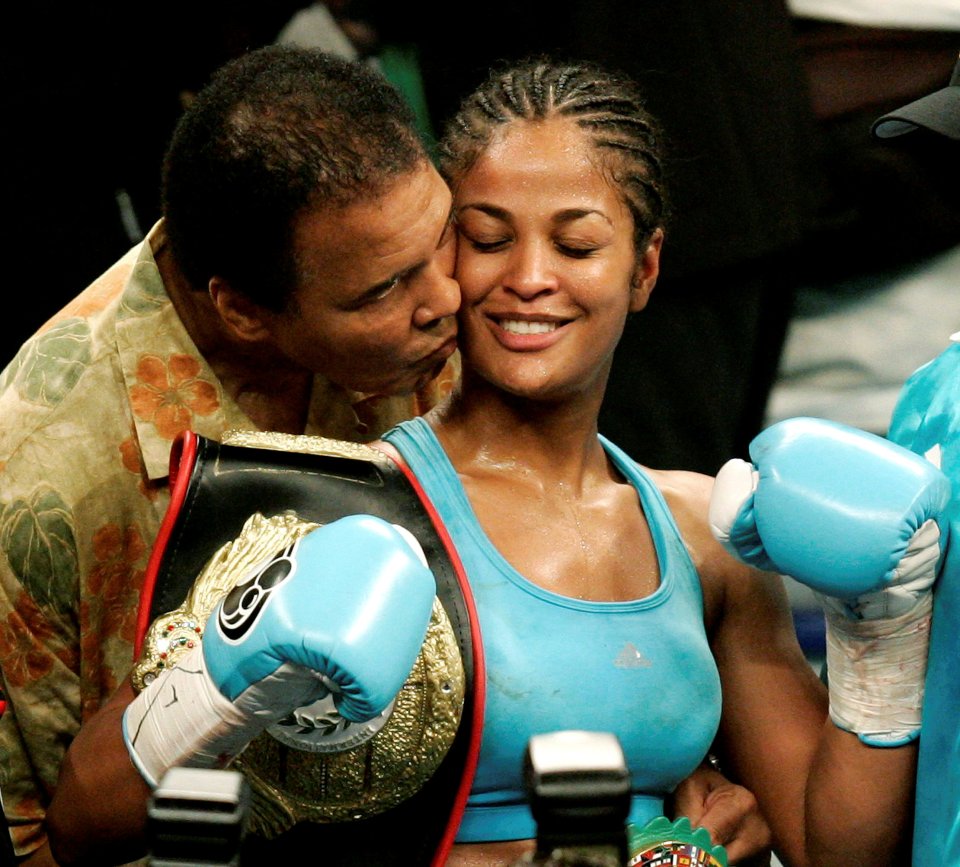 of WBC and WIBA super middleweight champion Laila Ali being kissed by her father, boxing great Muhammad Ali, at the MCI Center in Washington