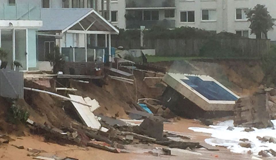 One of the million-pound homes lost its swimming pool on Monday as it was dragged into the raging seas