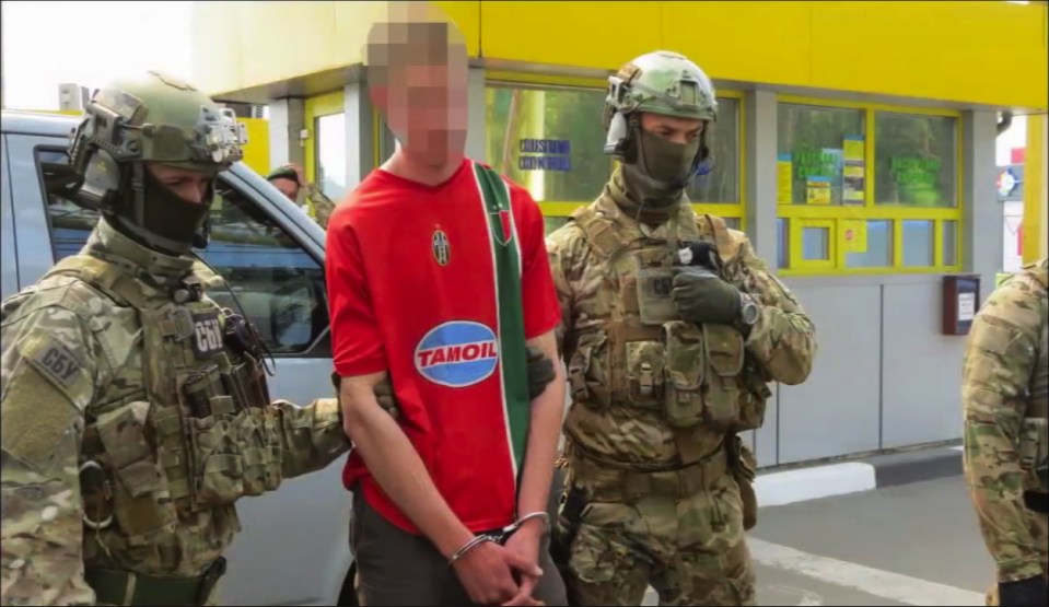 Arrest . . . man is led away after raid