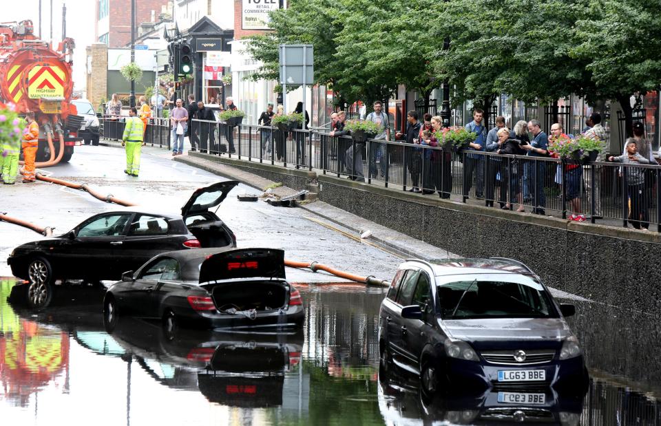 Three people were trapped in cars after they were submerged in water in flash floods in London