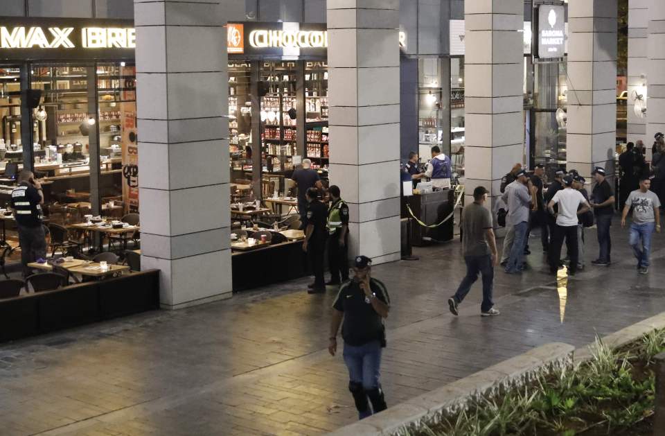 Israeli security forces gather at a shop