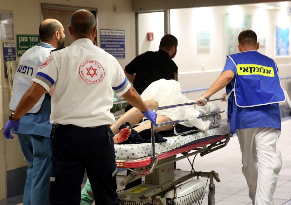 An injured person is taken into emergency room following a shooting attack that took place in the center of Tel Aviv
