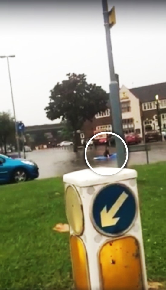 Onlookers were stunned as they watched the man canoe down a busy road in Birmingham after flash flooding chaos