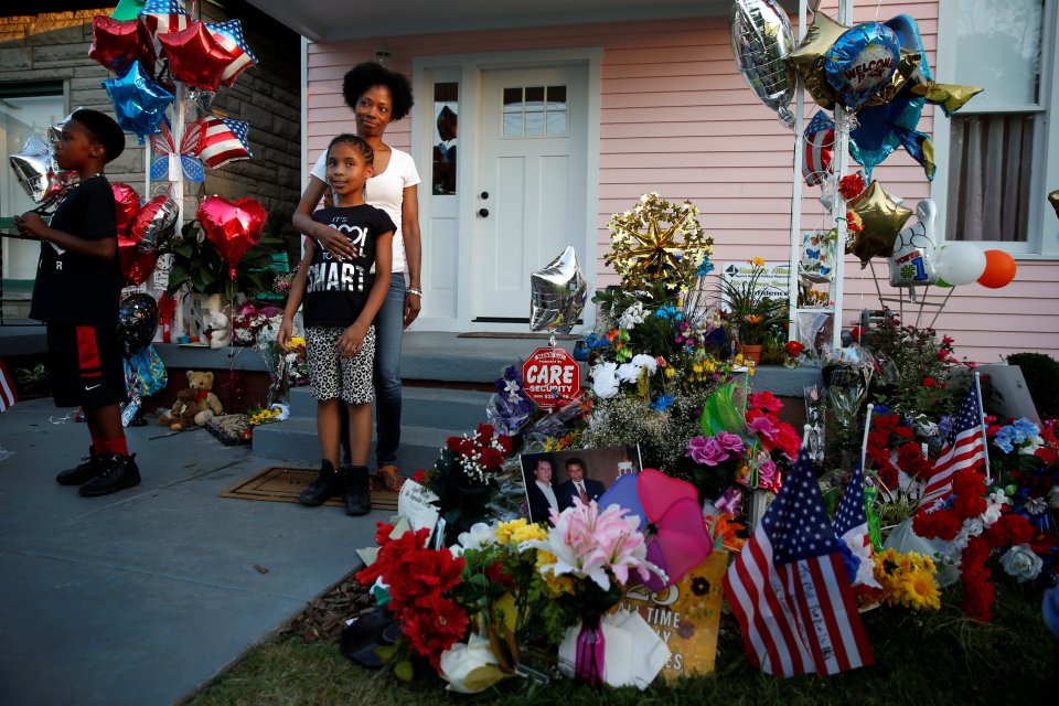 People pose for photos outside the childhood home of the late boxing champion Muhammad Ali in Louisville