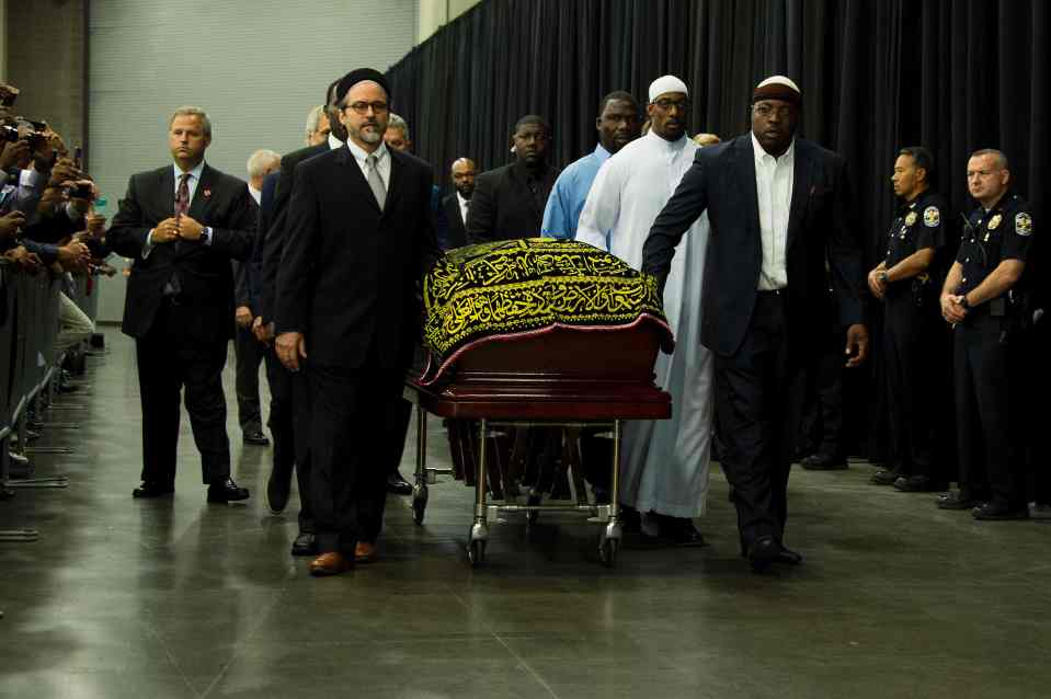 TOPSHOT - Pallbearers escort the casket