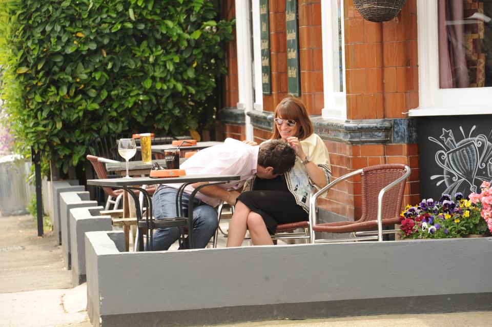 George and Gemma share a tender moment as they sit outside a cafe in Twickenham 