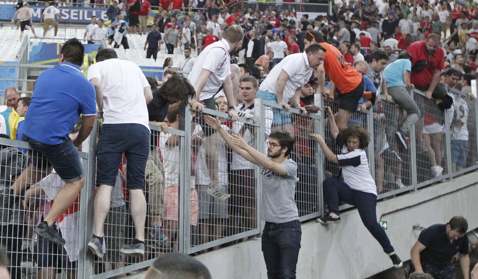 Terrified England fans clamber over stadium fences to escape gangs of Russian attackers