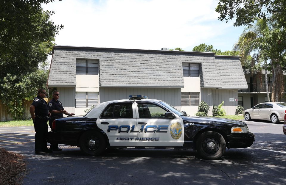 Police block the entrance to the apartment building in Fort Pierce, Florida, where the suspect is thought to have lived