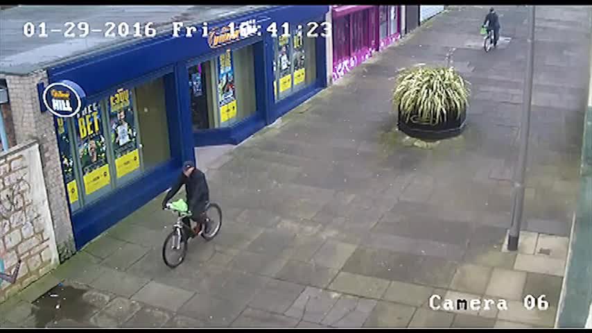 The two men approach the bank on their push bikes