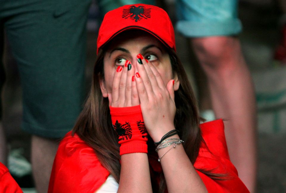 Albanias supporters react as they watch