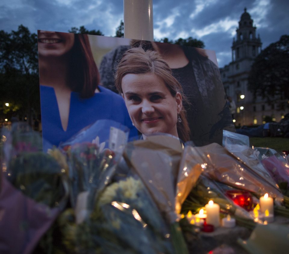 Flowers surround a picture of Jo Cox during a vigil in Parliament Square