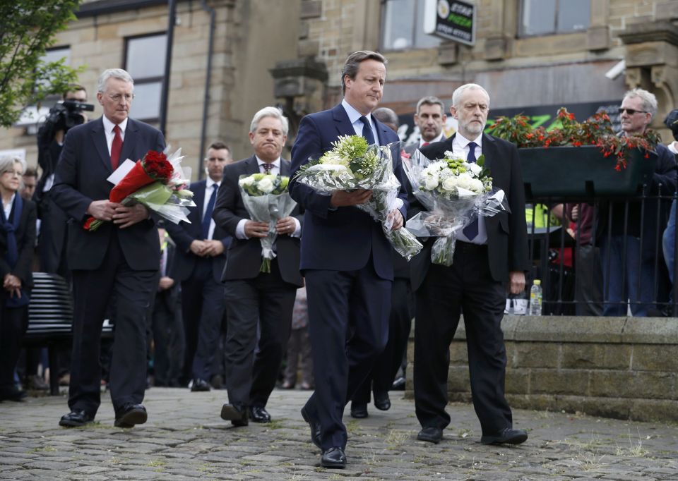 Shocked and saddened David Cameron lays flowers where Mrs Cox was slaughtered yesterday