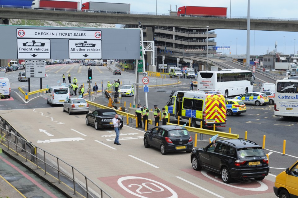 Cars line up and police vans are on standby after Calais port was shut down for almost two hours today