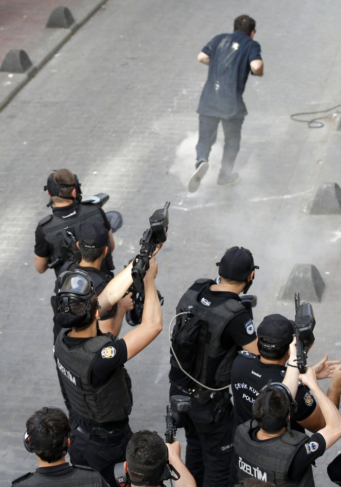 Turkish police officers fire tear gas and rubber bullets to disperse demonstrators who gathered for a gay pride rally despite a government ban
