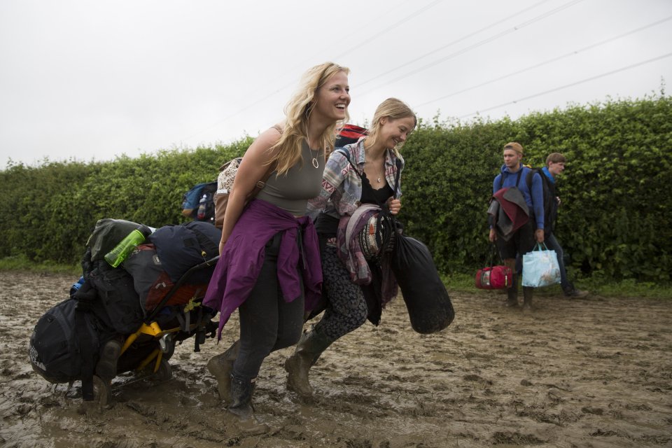 Two friends wade through the mud to get to their camping spot