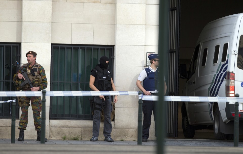 Police and Belgian Army soldiers patrol as a van arrives for a court hearing for suspect Mohamed Abrini at the Court of Appeals in Brussels Thursday, June 23, 2016. A Brussels appeals court panel met Thursday to consider France's extradition request for Abrini, 31, a suspect in the Paris and Brussels attacks, that were claimed by the Islamic State organization. (AP Photo/Virginia Mayo)