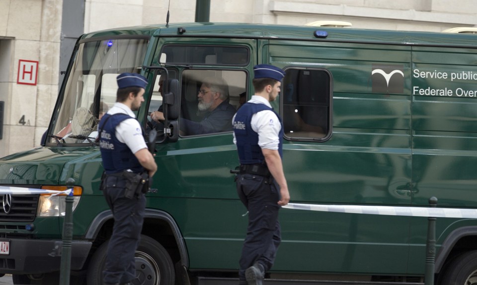 Police patrol as a van arrives for a court hearing for suspect Mohamed Abrini at the Court of Appeals in Brussels on Thursday, June 23, 2016. A Brussels appeals court panel met Thursday to consider France's extradition request for Mohamed Abrini, 31, a suspect in the Paris and Brussels attacks that were claimed by the Islamic State organization. (AP Photo/Virginia Mayo)