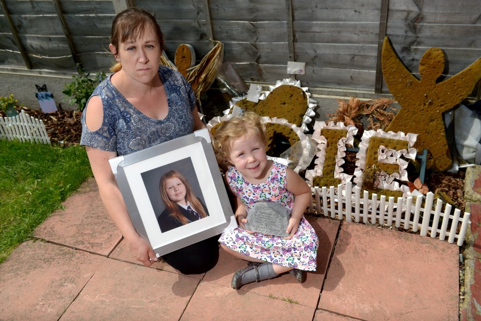 Nicola Rogers, mum of Jodie, by her memorial garden at home with her daughter Iesha, 4.