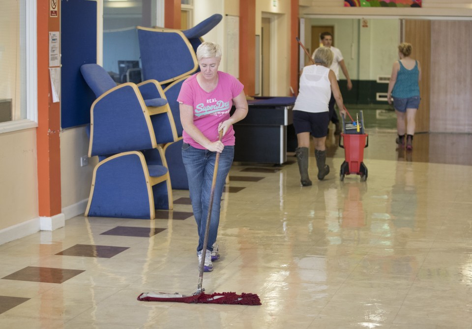 Staff clean up at Devon Way polling station after flooding forced it to be moved to another location