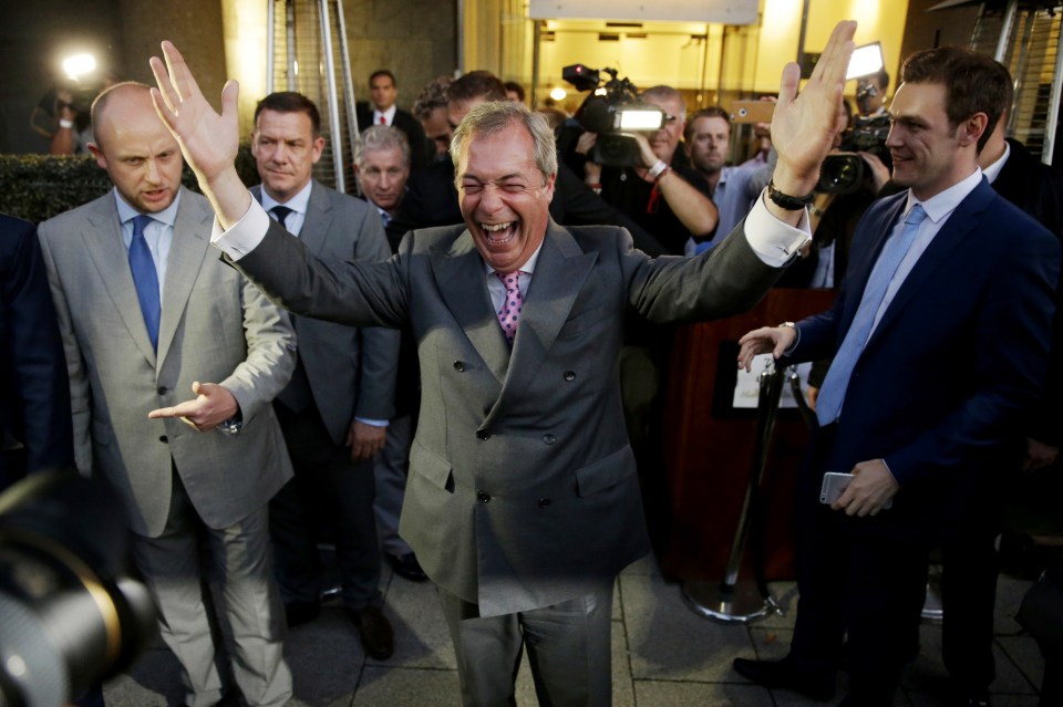 Nigel Farage, the leader of the UK Independence Party celebrates and poses for photographers as he leaves a "Leave.EU" organisation party saying his side has won
