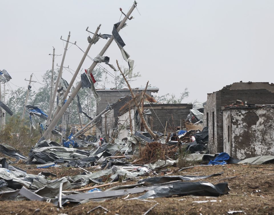 The storm, which flattened power lines, overturned cars and ripped roofs off houses in Jiangsu province, struck at mid-afternoon yesterday
