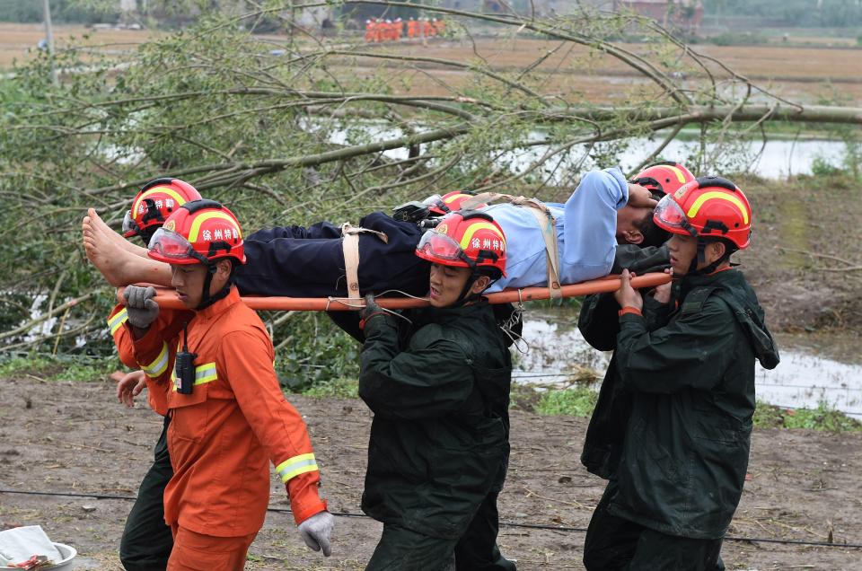 The death toll stood at 98, with 800 people injured, state-run China National Radio said on its website on Friday. Pictured, an injured man is carried from the scene
