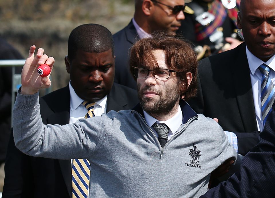 The man was led away by security guards following the incident