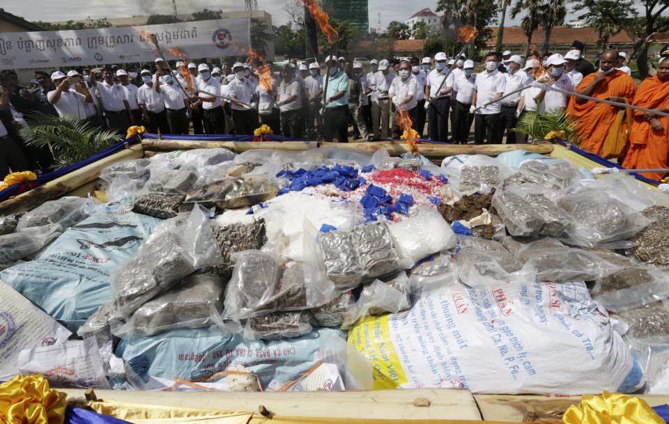  Cambodian officials ignite a stock of seized illegal drugs