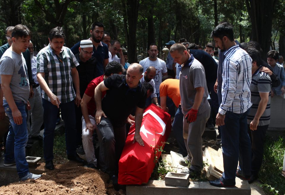 People bury the coffin of airport taxi driver Mustafa Biyikli, who lost his life in the following the suicide bomb attack in Istanbul Ataturk Airport 