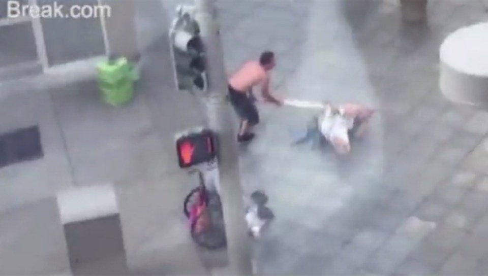 He knocks the man to the floor and hits him with the pole twice