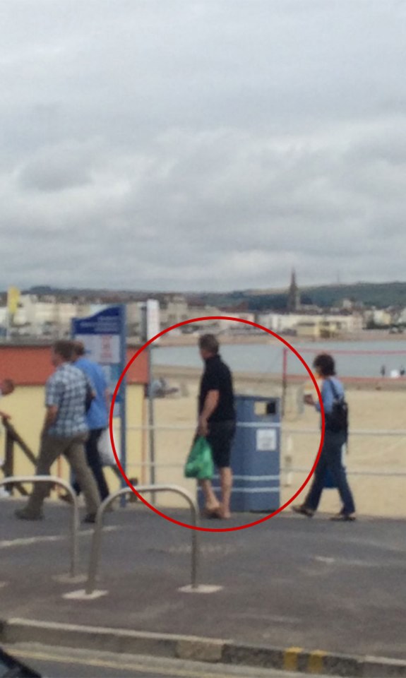 The PM was spotted with a carrier bag before his walk along the beach front