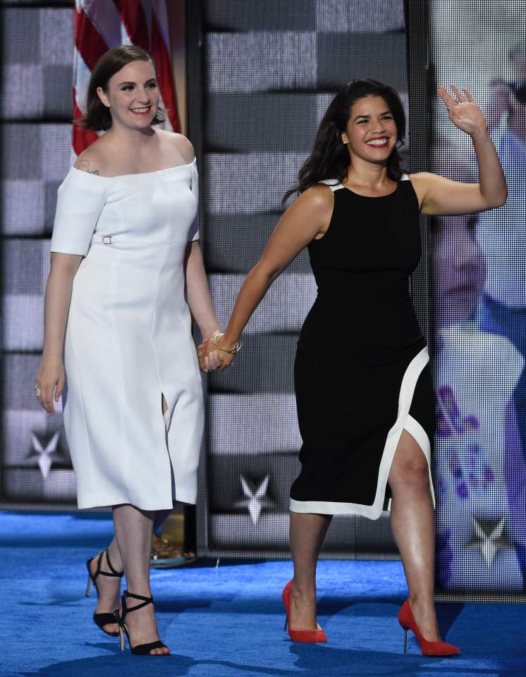 Actresses America Fererra (R) and Lena Dunham walk onto the stage during the second day of the Democratic National Convention at the Wells Fargo Center, July 26, 2016 in Philadelphia, Pennsylvania. / AFP PHOTO / SAUL LOEBSAUL LOEB/AFP/Getty Images